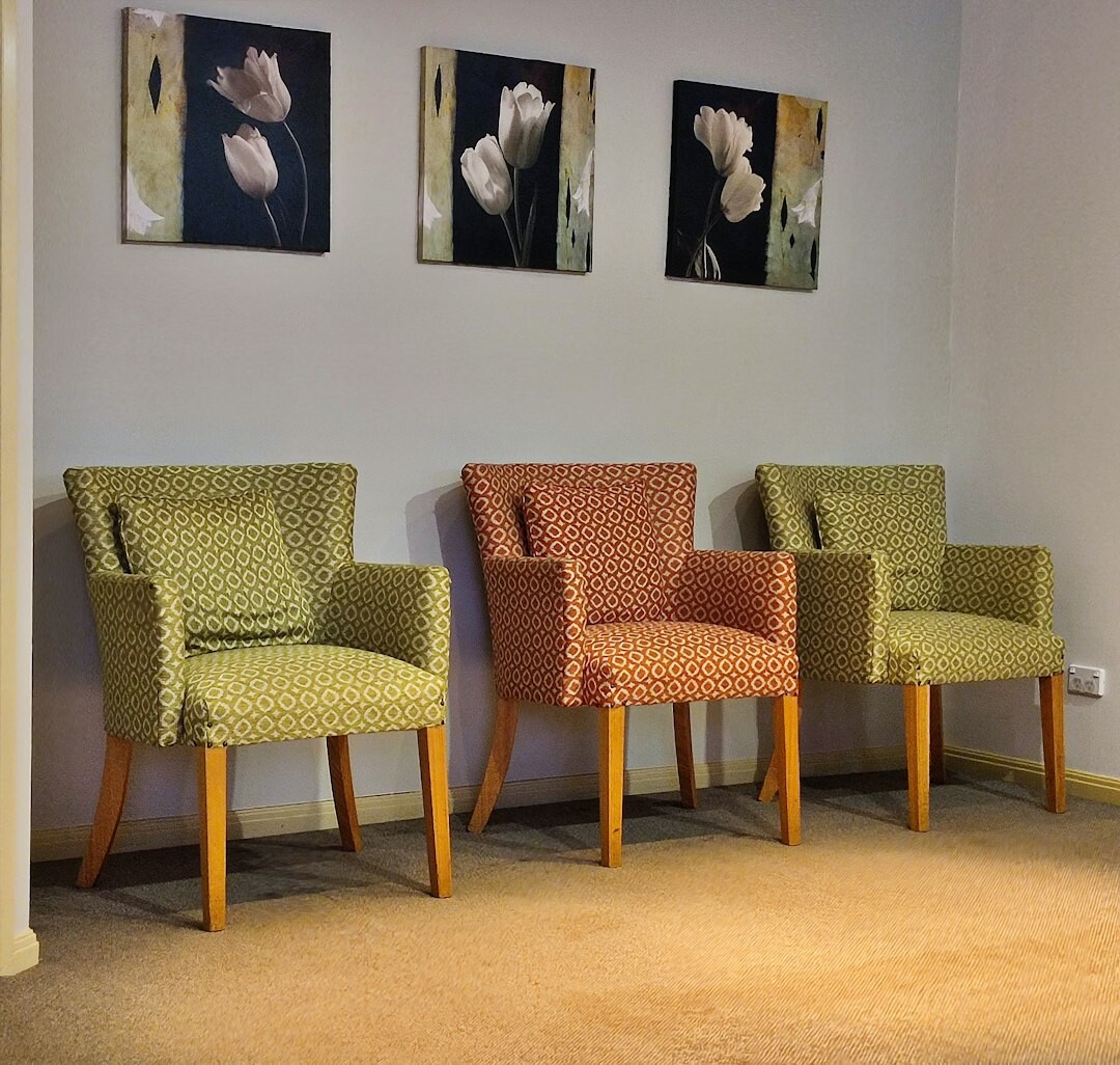 Elegant editorial office reception with bookshelves and a leather sofa