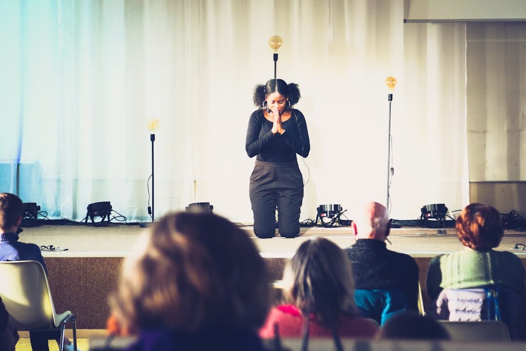 Speaker on stage at a design conference with an attentive audience